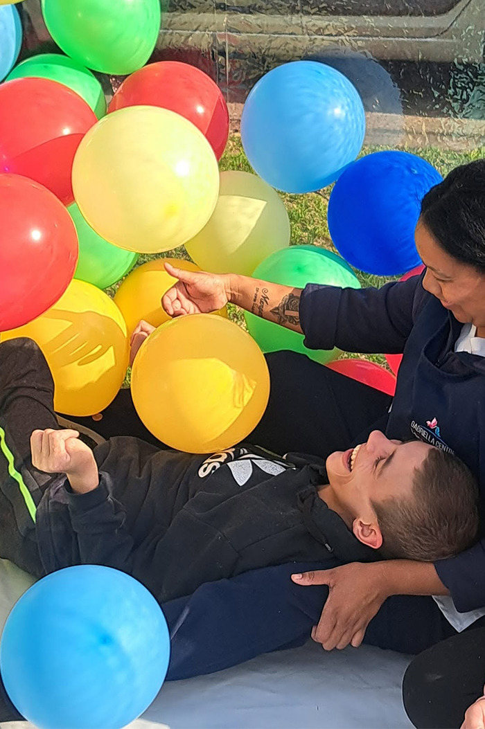 Gabriella Centre caregivers engaging in an activity with an attendee